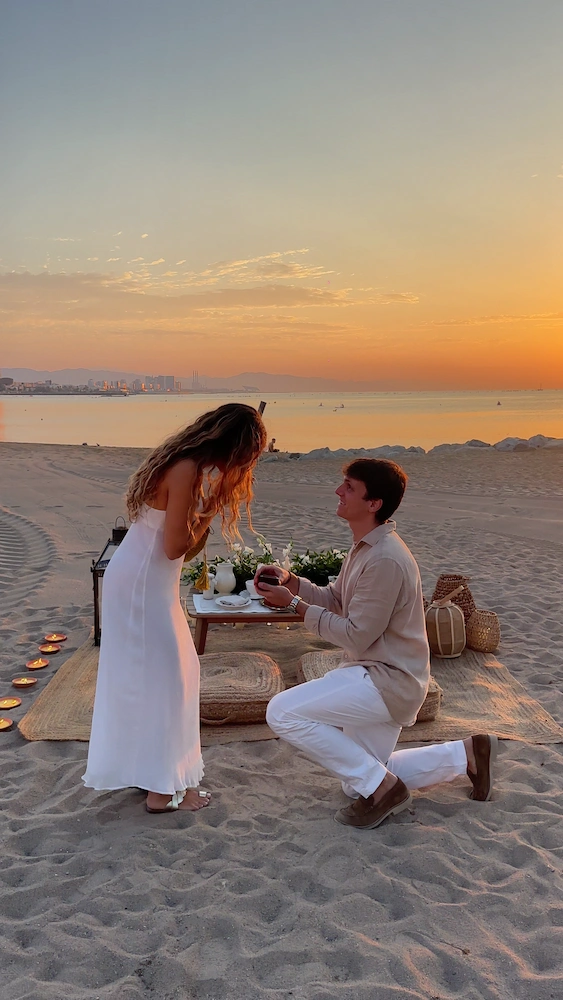 A seaside setup with sunset as a proposal service by Somnis Proposals